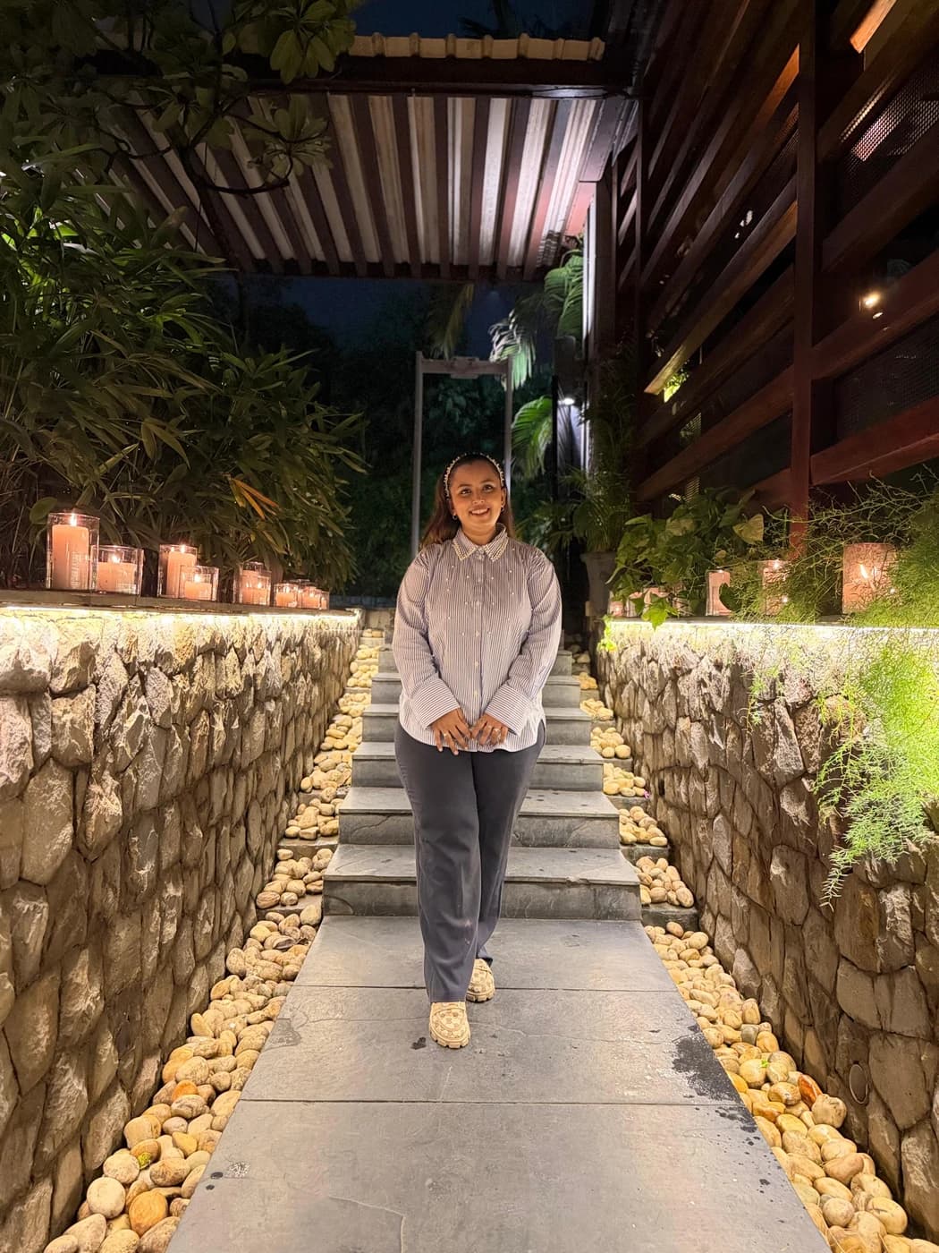 Aishwarya on a candlelit garden stairway